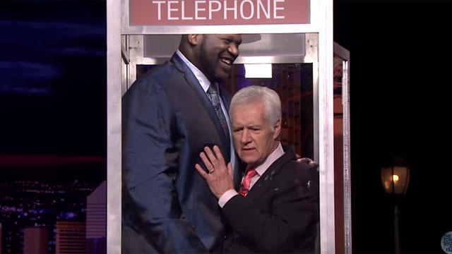 Shaq and Alex Trebek in a phone booth.jpg